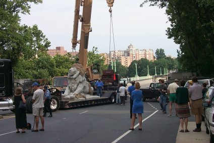 Lion being hoisted onto bridge